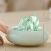 stone-blessings-hand-touching-green-fluorite-freeform-and-quartz-tower-in-a-glazed-jade-vessel-with-crystal-chip-bed-with-size Fluorite Vessel with Three Points with hand interaction and size reference