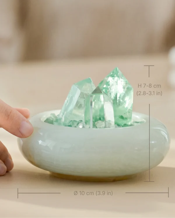stone-blessings-hand-touching-green-fluorite-freeform-and-quartz-tower-in-a-glazed-jade-vessel-with-crystal-chip-bed-with-size Fluorite Vessel with Three Points with hand interaction and size reference