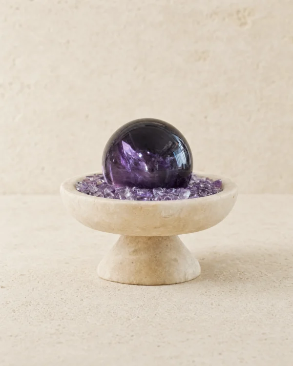 Stone Blessings amethyst sphere centerpiece on a textured stone vessel filled with chevron amethyst chips full front view