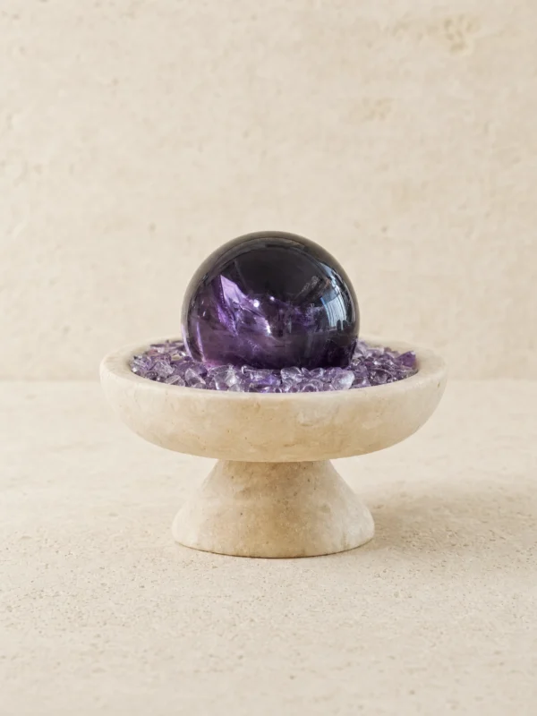 stone-blessings-amethyst-sphere-centerpiece-on-a-textured-stone-vessel-filled-with-chevron-amethyst-chips-full-front-view Stone Blessings amethyst sphere centerpiece on a textured stone vessel filled with chevron amethyst chips full front view