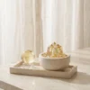 Citrine Cluster and Sphere Set on Travertine Tray styled with a sheer curtain