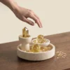 Citrine Three-Piece Set on Round Travertine Tray with hand interaction