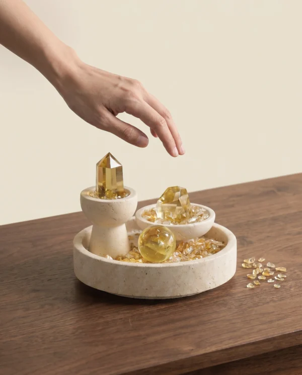 Citrine Three-Piece Set on Round Travertine Tray with hand interaction