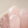 Stone Blessings close up of rose quartz towers and sphere showing the soft pink translucent stone texture