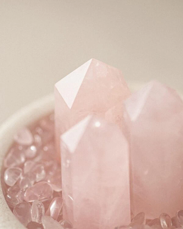 Stone Blessings close up of rose quartz towers and sphere showing the soft pink translucent stone texture