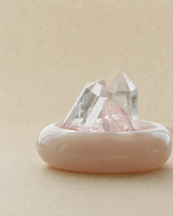 stone-blessings-close-up-of-two-clear-quartz-towers-and-a-rose-quartz-tower-rising-from-rose-quartz-chips-in-an-afghan-pink-jade-bowl Rose Quartz Points in Pink Marble Vessel close-up with clear quartz and rose quartz points