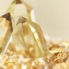 Stone Blessings close up of two polished citrine towers rising from a bed of citrine chips in a stone bowl