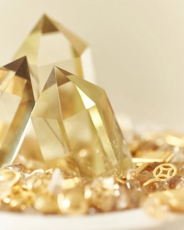 Stone Blessings close up of two polished citrine towers rising from a bed of citrine chips in a stone bowl