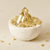 Stone Blessings natural citrine crystal bowl with a polished citrine tower in a stone vessel front view