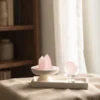 Rose quartz crystal centerpiece styled on linen in a quiet interior