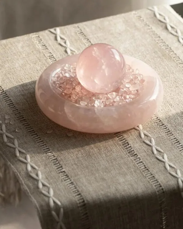 stone-blessings-rose-quartz-sphere-in-an-afghan-pink-marble-bowl-styled-on-soft-cream-fabric-in-a-calm-minimal-setting Stone Blessings rose quartz sphere in an Afghan pink marble bowl styled on soft cream fabric in a calm minimal setting