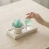 Fluorite Points and Sphere on Travertine Tray with hand interaction